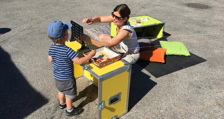 Photo d'une mère et son fils jouant au puissance 4 sur l'Ideas Box à Stockholm