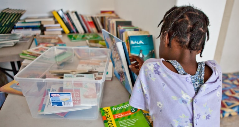 Photo d'une jeune fille de dos avec des livres